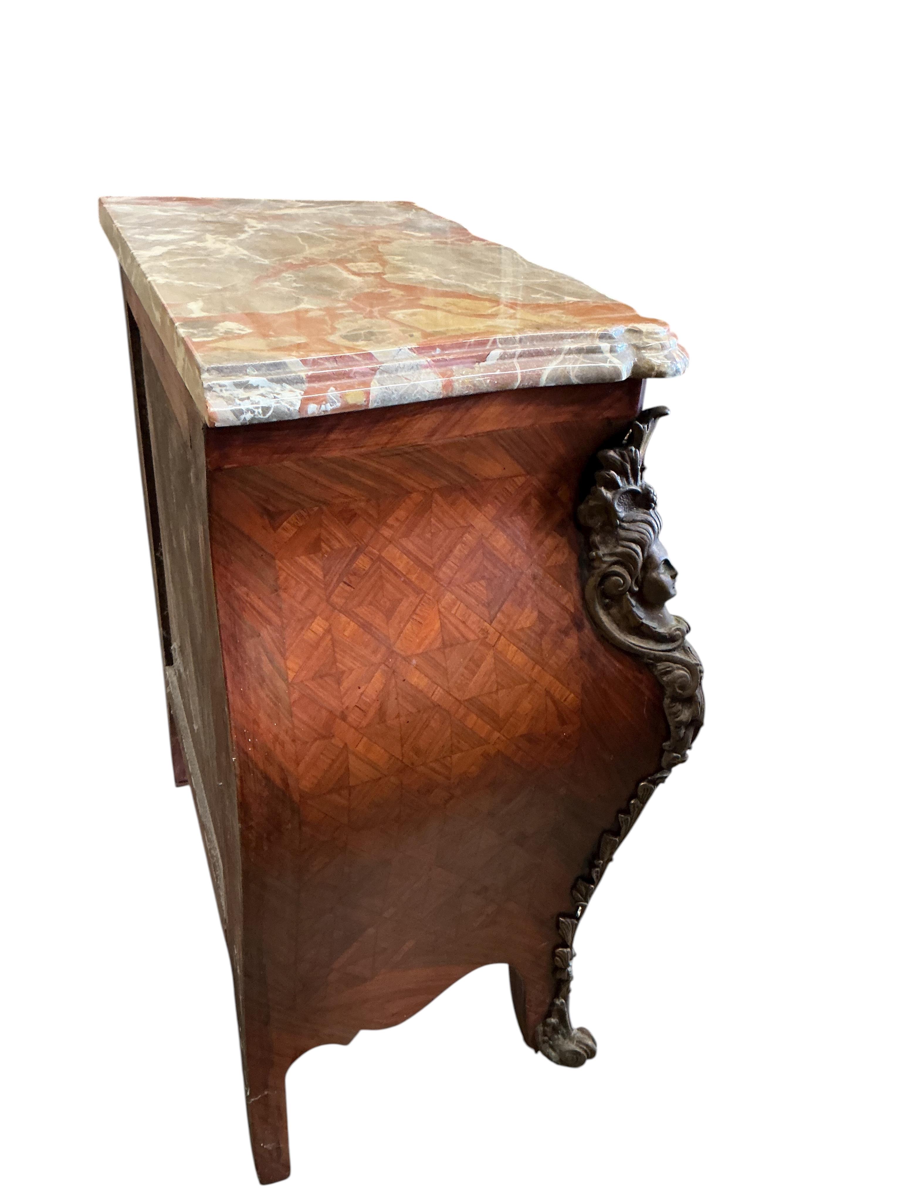 A pair of French transitional style bombe gilt metal mounted onyx top three drawer bedside chests, width 61cm, depth 33cm, height 71cm